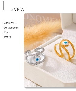Detail of adjustable evil eye rings in gold and silver finish with wave texture