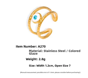 Detail view of gold stainless steel layered ring with blue devil eye enamel pendant