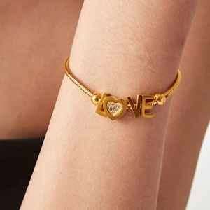 Gold 18K plated stainless steel LOVE bracelet with heart zircon detail on model wrist