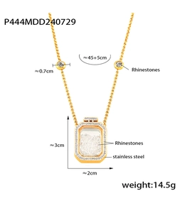 Close-up of golden stainless steel perfume bottle pendant with rhinestones details