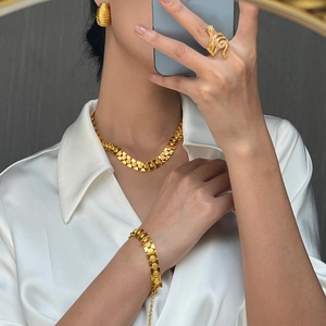 18K gold plated geometric jewelry set with chunky necklace and snake ring on a model