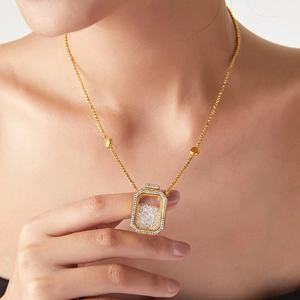 Golden perfume bottle pendant necklace with sparkling diamonds on a square chain