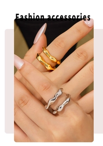 Close-up of irregular wave rings in gold and silver showing layered stacking style