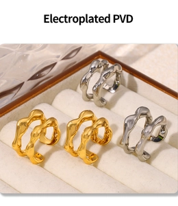 Detailed macro view of gold and silver irregular flow rings with PVD plating