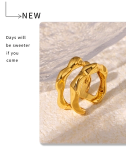 Macro view of irregular wave-textured golden ring with liquid metal design and glossy finish