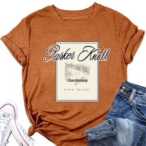 Detailed close-up of vintage print on burnt orange cotton t-shirt with flat lay styling