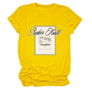 Close-up of bright yellow T-shirt featuring vintage Parker Knoll wine label print