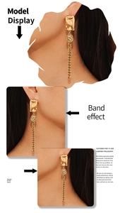 Close-up of geometric portrait pendant earrings with golden chain tassels on a model
