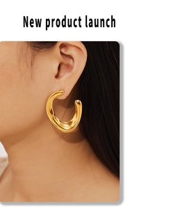 Close-up of geometric U-shaped thick hoop earring in 18k gold plated stainless steel