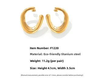 Detailed view of U-shaped gold plated titanium steel earrings with irregular curved surface