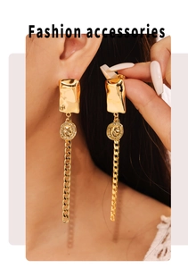 Close-up of gold coin earrings with portrait embossing and long chain tassels for women
