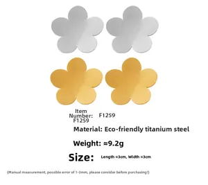 Macro detail of polished 18k gold plated five-petal flower earrings in silver and gold