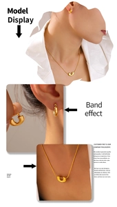 Detail of 18k gold plated U-shaped pendant necklace and hoop earrings jewelry set