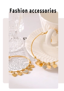Detail of 18k gold plated beaded bracelet featuring polished and pavé heart charms