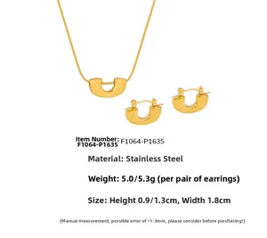 Detail of 18k gold plated stainless steel U-shaped pendant necklace and earring set