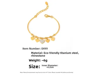 Close-up of gold heart charm bracelet in titanium steel with sparkling rhinestones