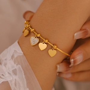 Elegant 18K gold plated titanium bracelet with sparkling heart charms and zircon tassels