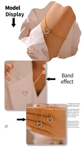 Detail of 18k gold plated hollow heart necklace and layered bracelet set on model