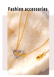 Detail of a gold-plated necklace with a silver hollow heart pendant and lobster clasp