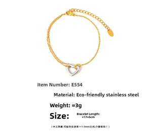 Detail of 18k gold plated stainless steel double chain bracelet with hollow heart charm