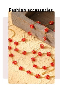 Detail view of red floral beaded necklace and bracelet set on vintage wood tray