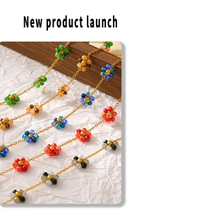 Detail of bohemian colorful crystal beaded flower pendant with golden necklace set