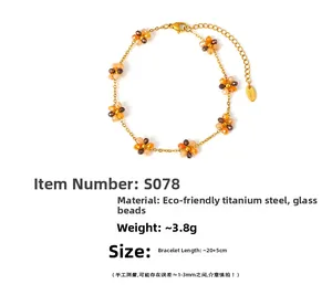 Detailed shot of 18k gold plated titanium steel anklet with amber glass floral beads