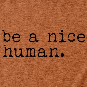 Détail du t-shirt en coton orange brûlé avec impression texte 'be a nice human'