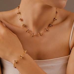Bohemian floral beaded necklace and bracelet set in gold titanium steel on a model