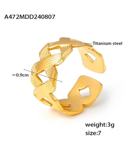 Macro detail of gold titanium steel ring with hollow woven texture and size specifications