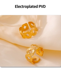Macro view of gold PVD plated braided texture ring on soft cream silk background
