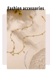 Detailed macro of gold plated chain necklace with elegant white pearls and beads