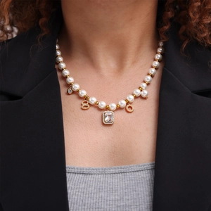 Vintage 18k gold plated pearl necklace set with geometric zircon pendants worn by model
