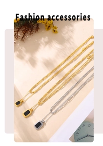 Detail view of double-layered titanium necklaces with black rectangular pendants in gold and silver