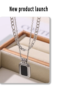 Detail of silver double-layer necklace with rectangular black pendant and Figaro chain