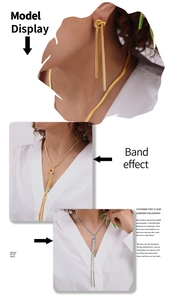 Detail of gold and silver knot tassel snake chain necklace and earring set on model