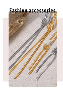 Detailed shot of gold and silver knotted snake chain necklaces on a modern display base