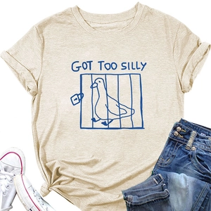 Flat lay of beige 'GOT TOO SILLY' duck print t-shirt with jeans and canvas shoes