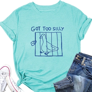 Flat lay of teal cotton T-shirt with GOT TOO SILLY duck print, denim shorts and sneakers