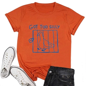 Flat lay of orange cotton T-shirt featuring 'GOT TOO SILLY' duck graphic and casual shorts