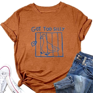 Detail of caramel t-shirt featuring a blue graphic of a duck and Got Too Silly text