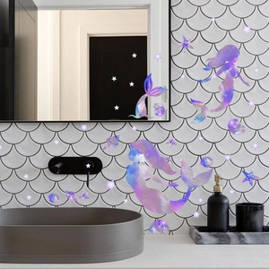 Detailed view of watercolor mermaid and starfish wall decals on bathroom tiles