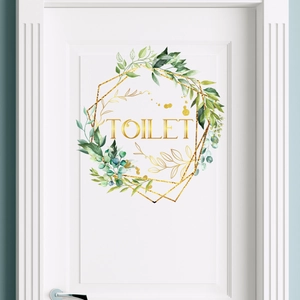 Watercolor green leaf wreath toilet door sticker with gold geometric frame on white door