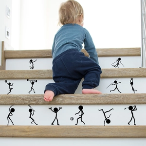 Close-up of black stickman sports wall stickers on wooden stairs for home gym decor