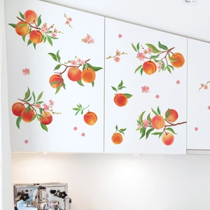 Detail of peach and blossom wall stickers applied on a modern white kitchen cabinet