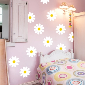 Gros plan de stickers muraux marguerites blanches sur un mur rose de chambre à coucher
