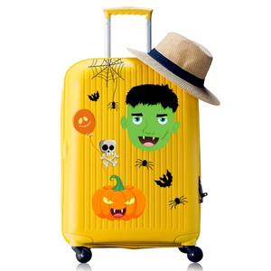 Close-up of vibrant yellow Halloween suitcase featuring Frankenstein and pumpkin decals