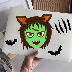 Close-up of Halloween monster laptop stickers featuring Frankenstein and bat designs