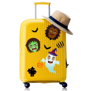 Cartoon Halloween stickers with monsters and ghosts displayed on a yellow suitcase