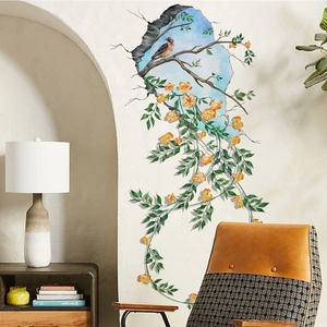 3D wall sticker with yellow flowers and bird on branch against blue sky broken wall effect